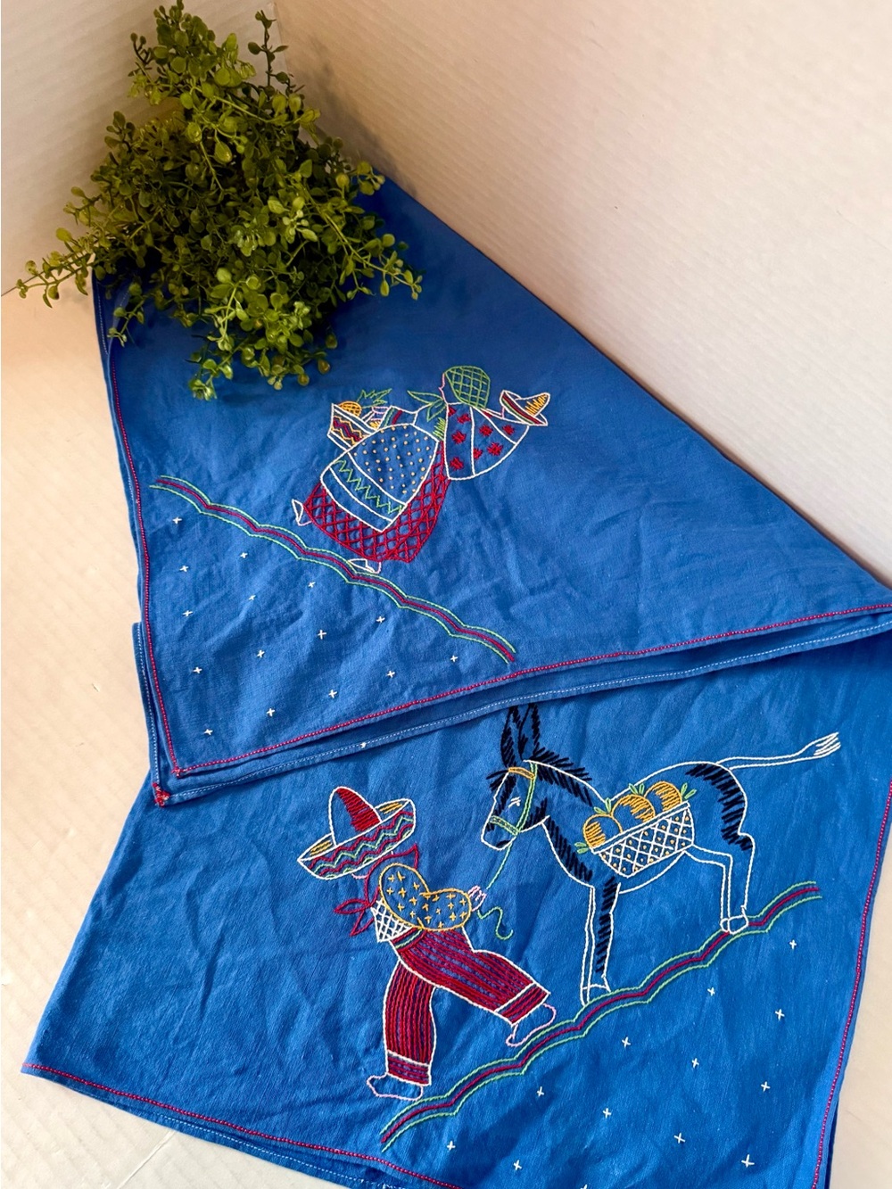 Cotton table runner with hand-embroidered folk art